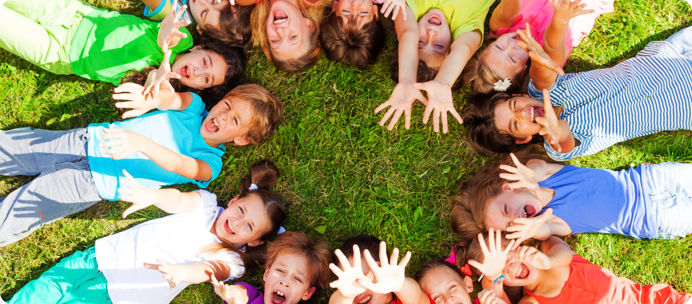 Children laying on the ground forming a circle