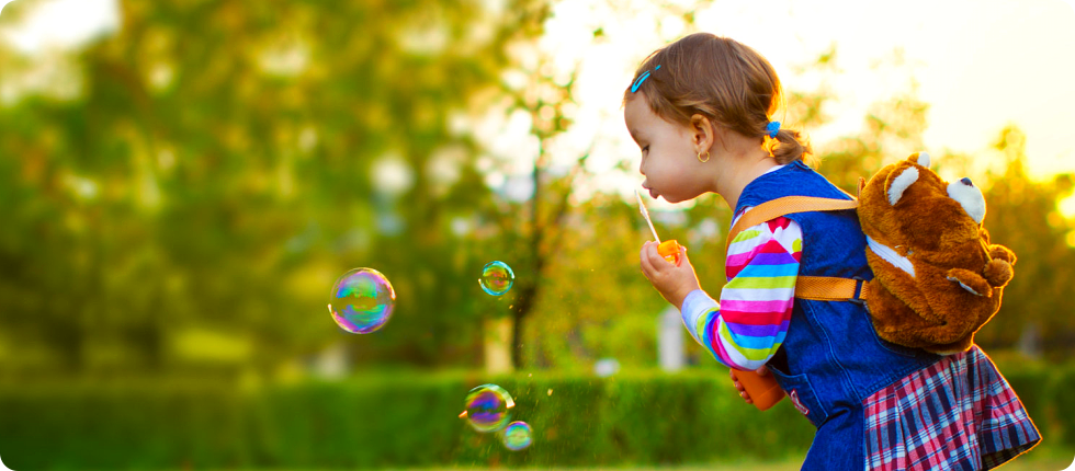 A little girl blowing bubbles