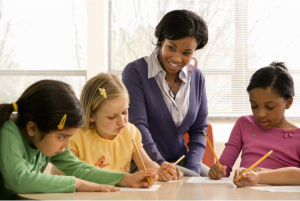 teacher teaching the kids how to write